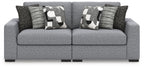 Loveseat sofa in light gray with patterned pillows and dark accent pillows