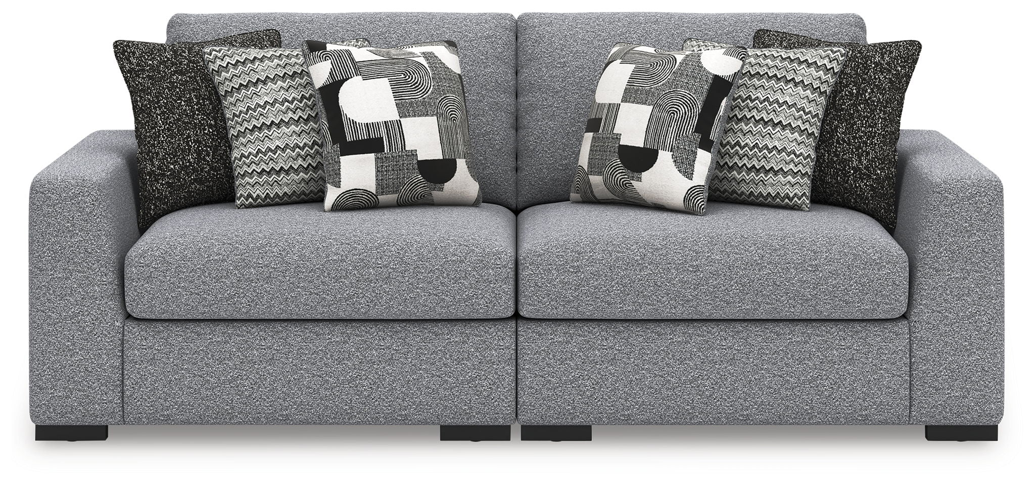 Loveseat sofa in light gray with patterned pillows and dark accent pillows