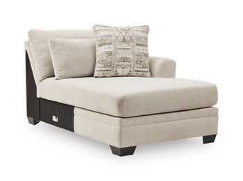 Light beige upholstered corner chaise with two cushions and patterned decorative pillow