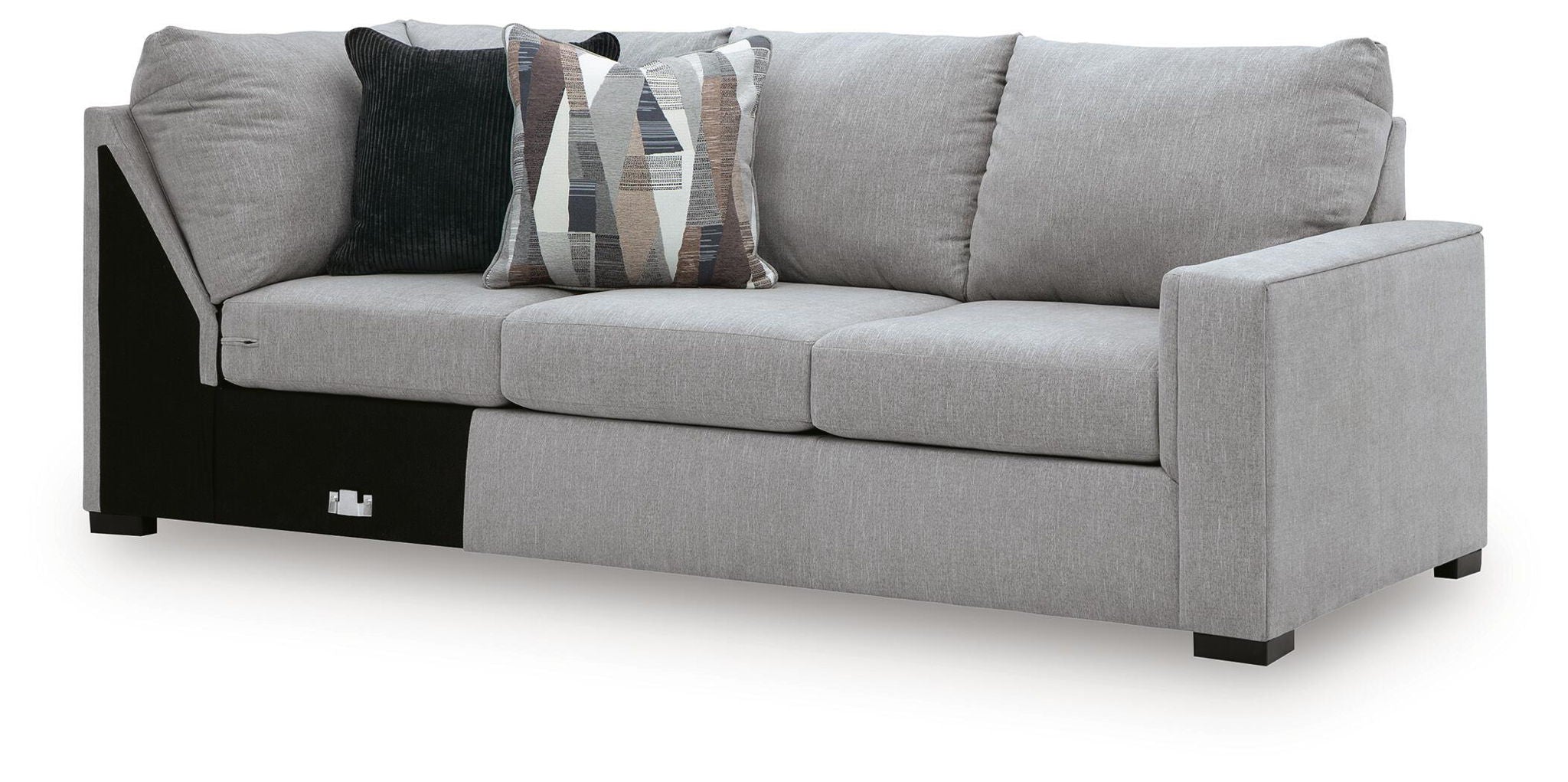 Gray fabric sofa with corner wedge, cushioned armrests, patterned and dark throw pillows, black legs
