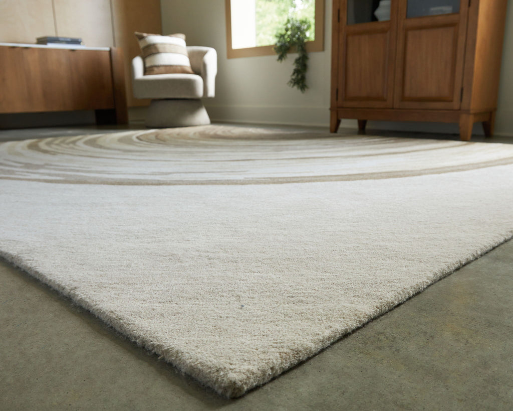 Rug with dark wave stripe center and cream field, textured low pile corner