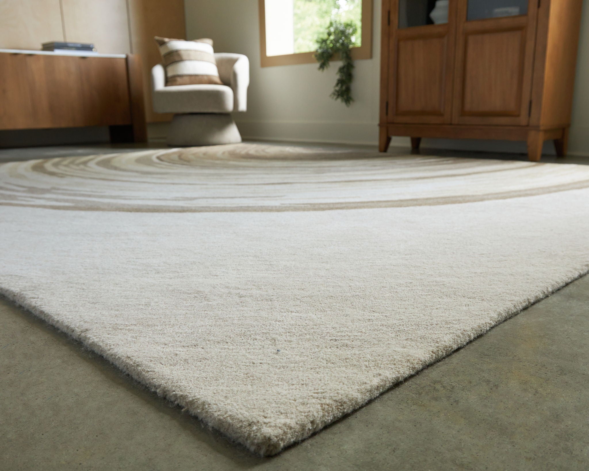 Rug with dark wave stripe center and cream field, textured low pile corner