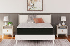 Plush gray mattress on a dark base with patterned cover and pillows