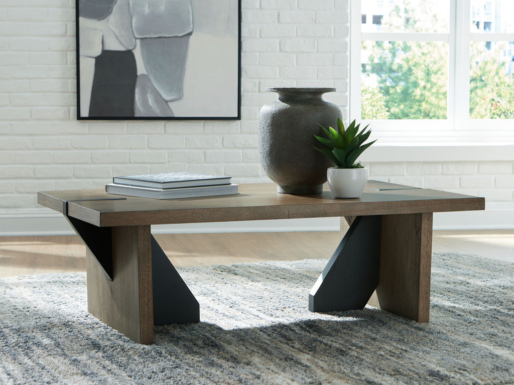 Light brown living room table with angled openwork supports and wide tabletop