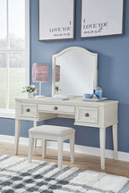 Antique white mirrored vanity with four drawers and an upholstered stool