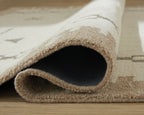 Light brown area rug with folded edge and beige shaggy texture