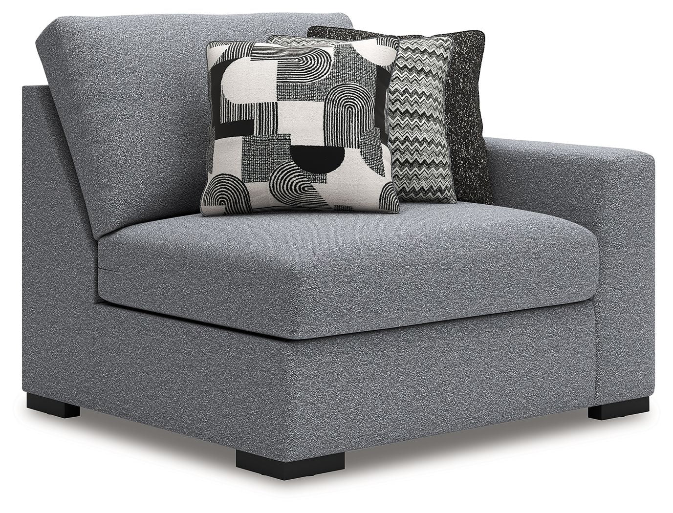 Gray upholstered chaise corner chair with rounded back and large patterned back pillow