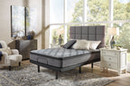 Gray firm mattress with quilted top and black edge trim on bed frame