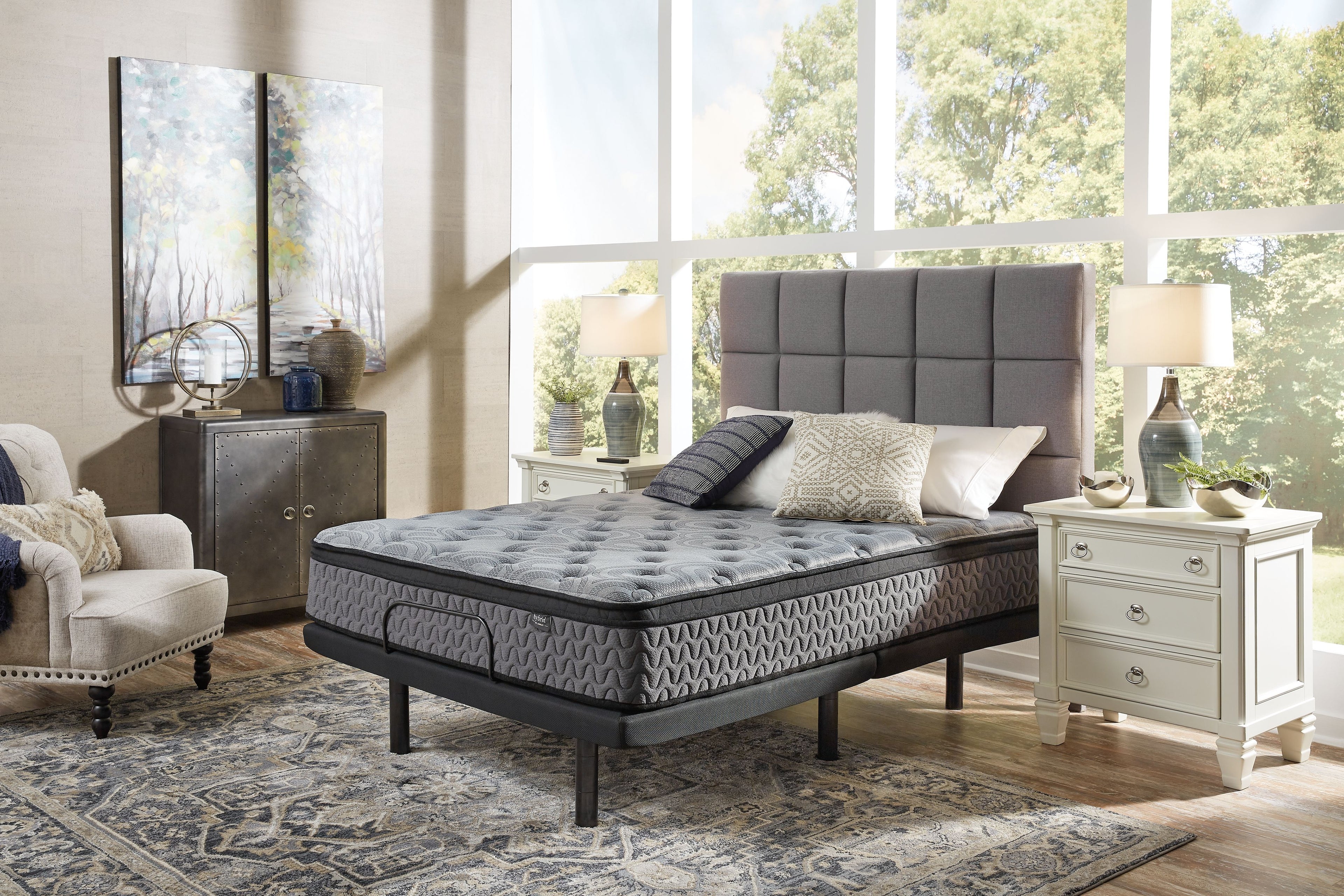 Gray firm mattress with quilted top and black edge trim on bed frame