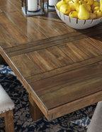 Close-up of grayish brown plank dining table top with beveled edges and corner trim