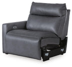 Dark gray upholstered power recliner with arm control panel and open footrest
