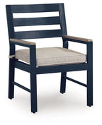 Blue arm chair with beige cushion and slatted back