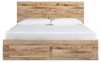Beige storage bed with two front drawers and a white mattress