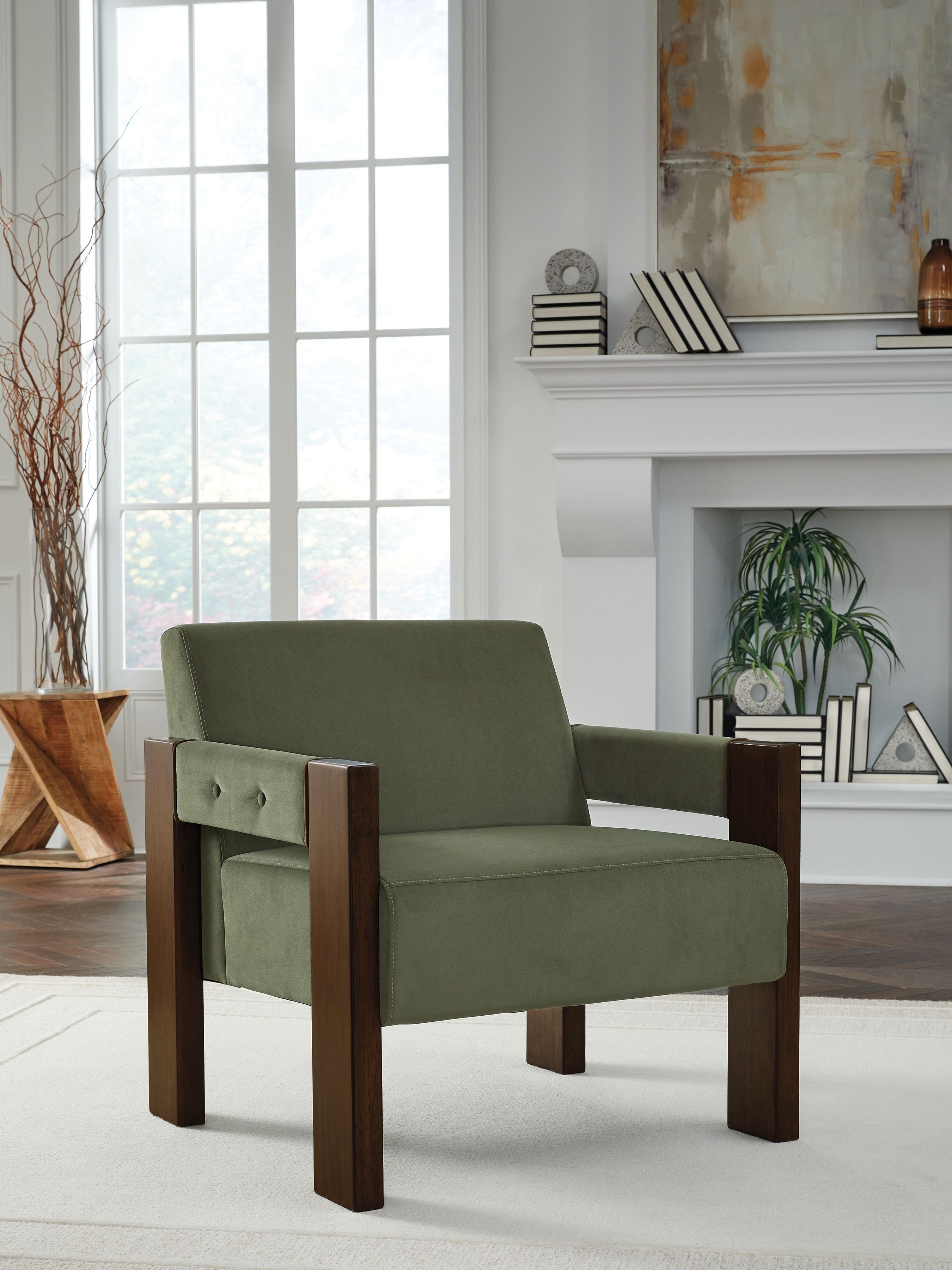 Green accent chair with dark wood arms and wide upholstered backrest