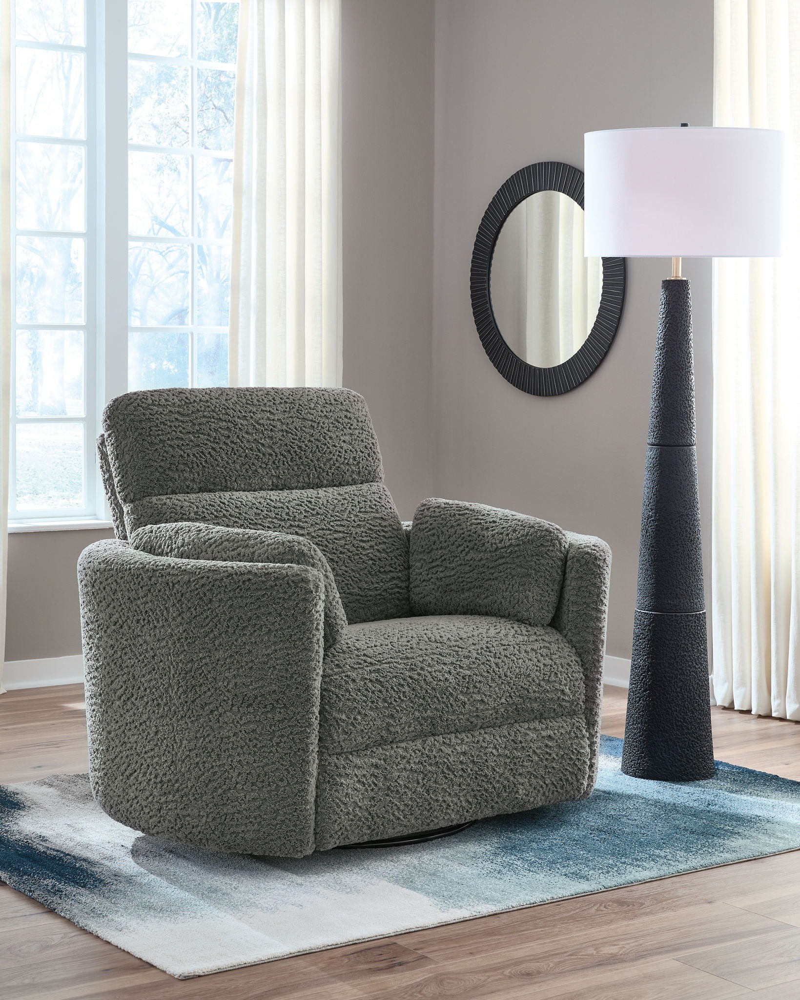 Swivel glider recliner chair in dark gray with rounded arms and textured boucle-like fabric