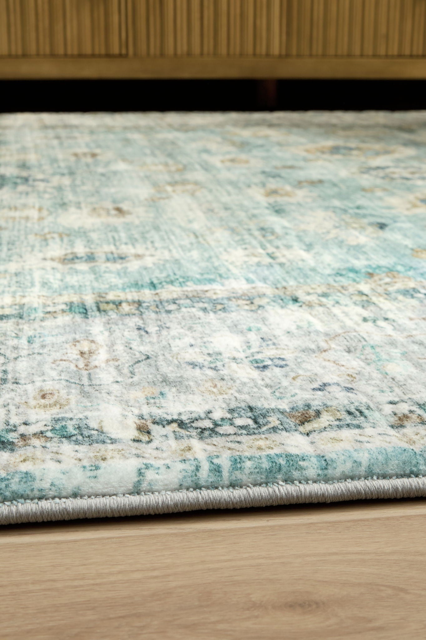 Ladstoney rug close-up with distressed blue lines and light speckled background