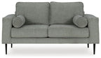 Charcoal loveseat with rolled arms and two round accent pillows, straight backrest