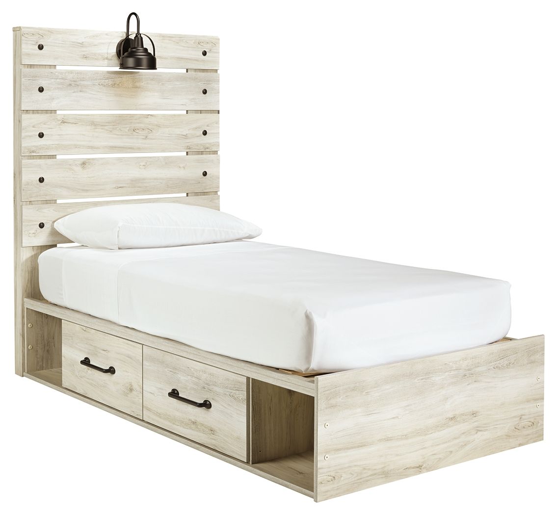 Panel bed with beige light-wood frame and two front drawers, white mattress and pillows.