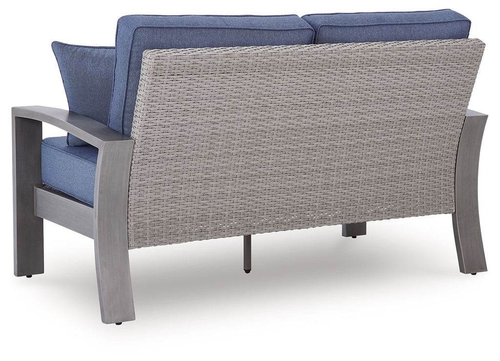 Blue loveseat with gray woven back panel, padded seat cushion and armrests