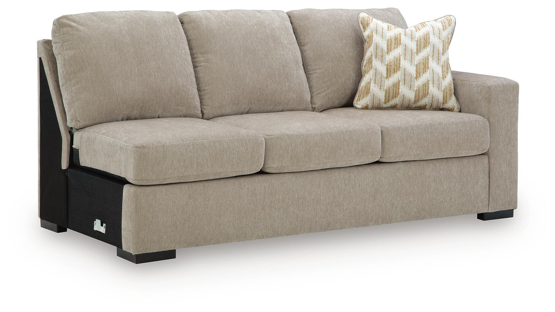 Stone-beige sofa with three back panels, dark legs, and patterned throw cushion