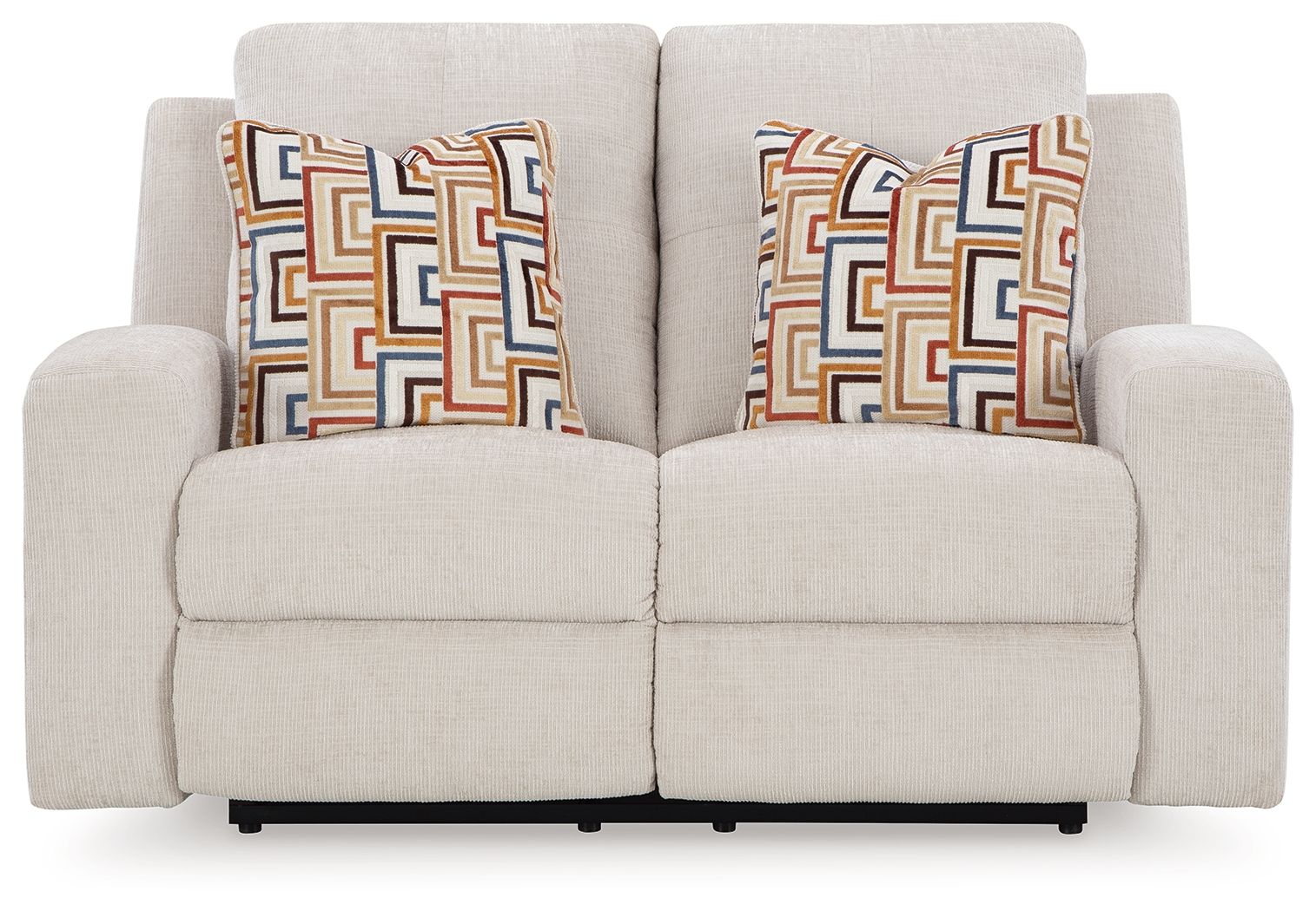Reclining loveseat with light beige upholstery and two patterned throw pillows