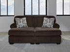 Chocolate sectional sofa with two accent pillows and wide armrests