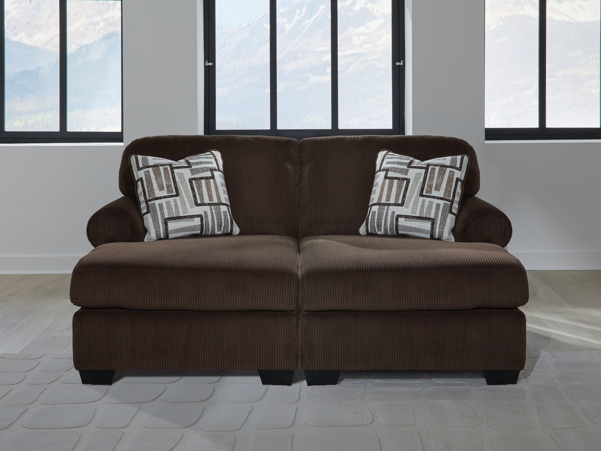 Chocolate sectional sofa with two accent pillows and wide armrests