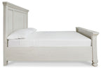White panel bed frame with one pillow, low side rails and paneled headboard