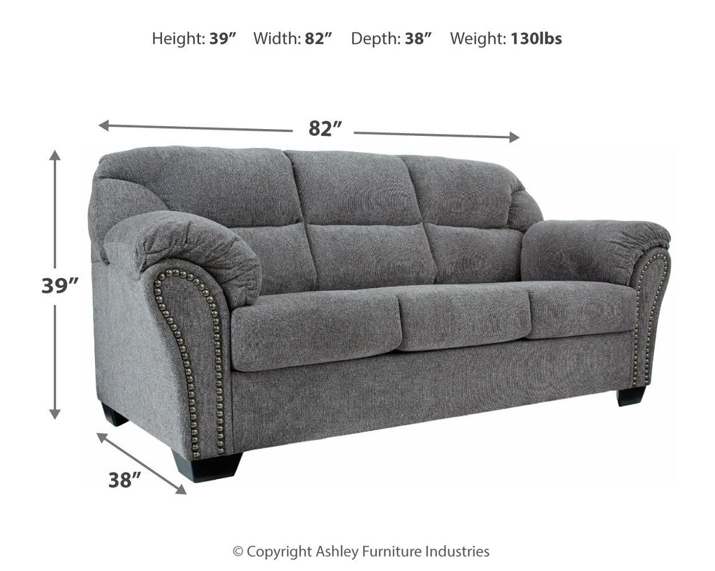 Pewter gray fabric sofa with tufted cushions and studded trim along arms