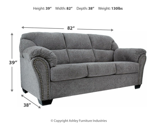 Pewter gray fabric sofa with tufted cushions and studded trim along arms