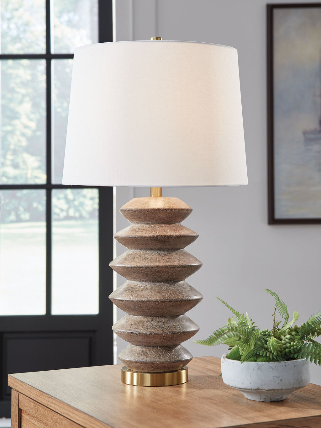 Poly table lamp with white shade, stacked brown sections, and gold stem