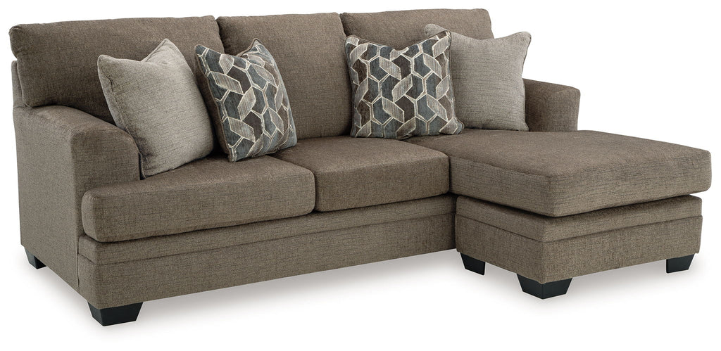 L-shape sectional sofa with chaise in medium brown fabric and three geometric throw pillows