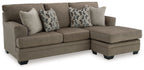 L-shape sectional sofa with chaise in medium brown fabric and three geometric throw pillows
