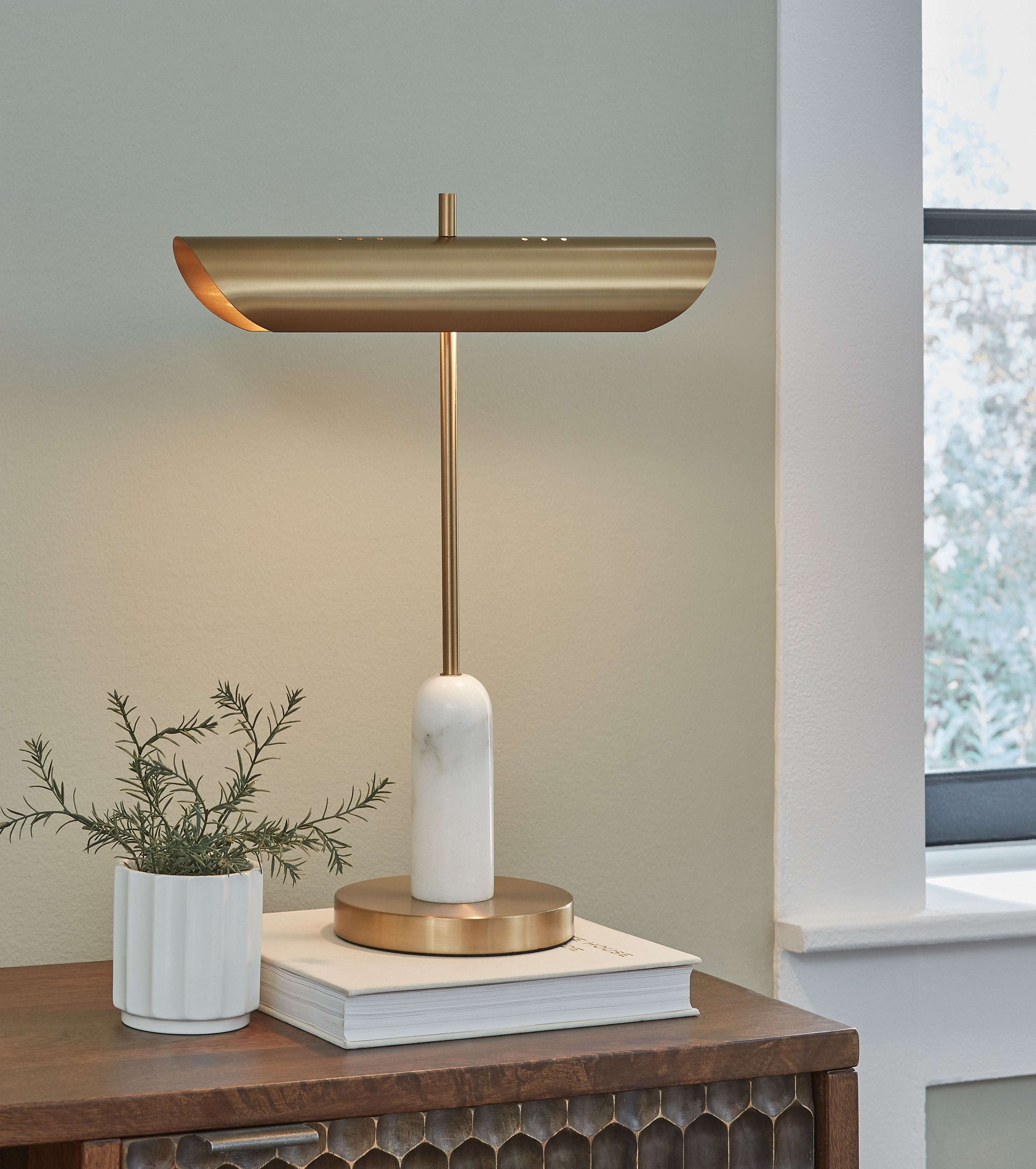 Rowleigh marble desk lamp on desk with gold shade and white marble base