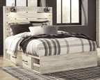 Light wood bed with plaid bedding and openwork headboard, with drawer nightstand