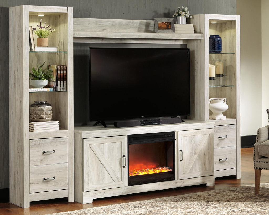 Beige entertainment center with TV cabinet, open shelves, and glass-front electric fireplace