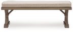 Beige padded bench seat with dark wood frame and tapered legs