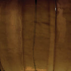 Amber glass table lamp close-up with vertical ribbing and amber finish