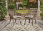 Two beige wicker armchairs with gray cushions and open slatted backs, armrests
