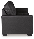 Black leather-look recliner chair with tufted back and rolled arm, square seat