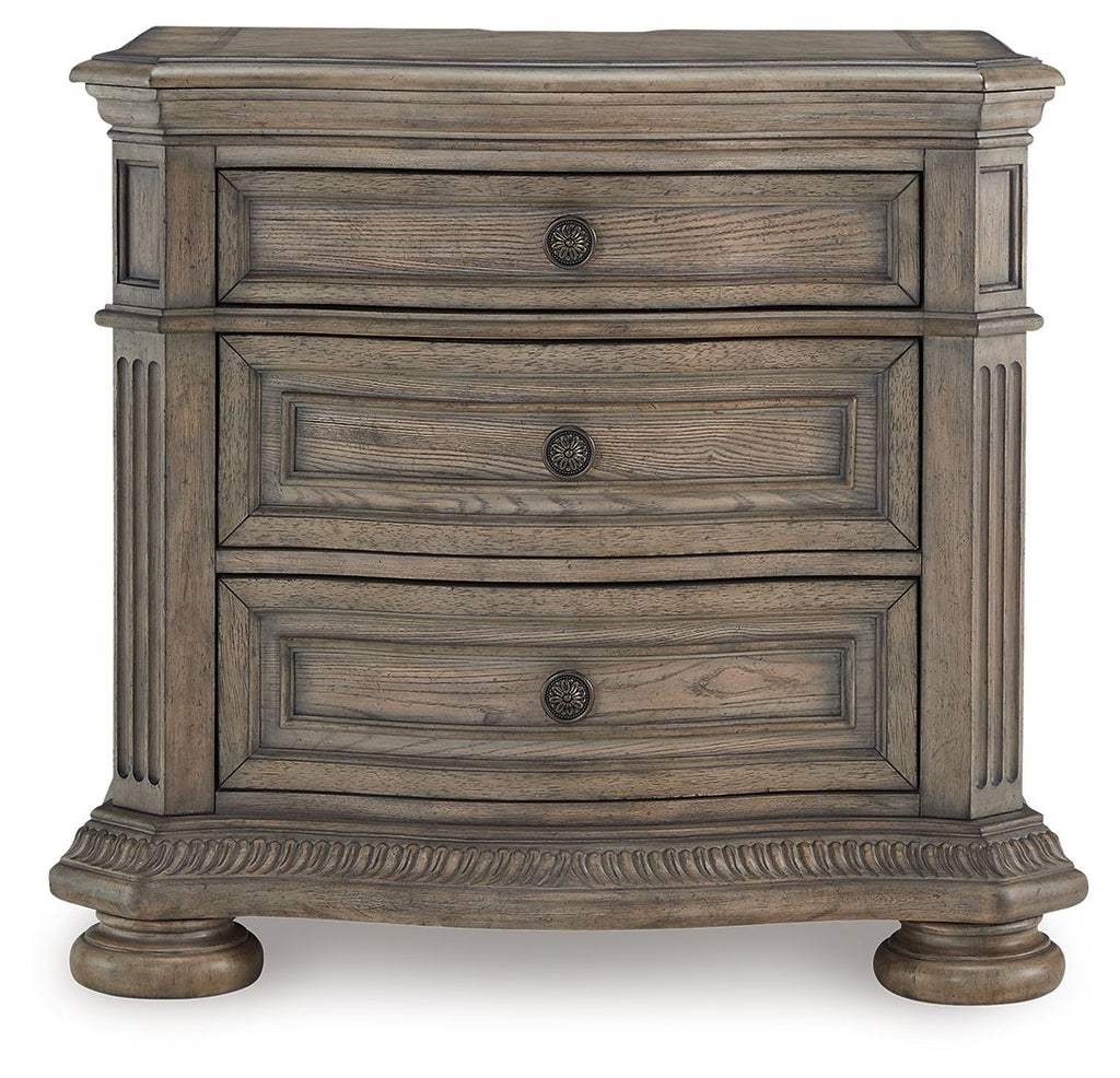 Light brown nightstand with three stacked drawers and round hardware knobs