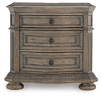 Light brown nightstand with three stacked drawers and round hardware knobs