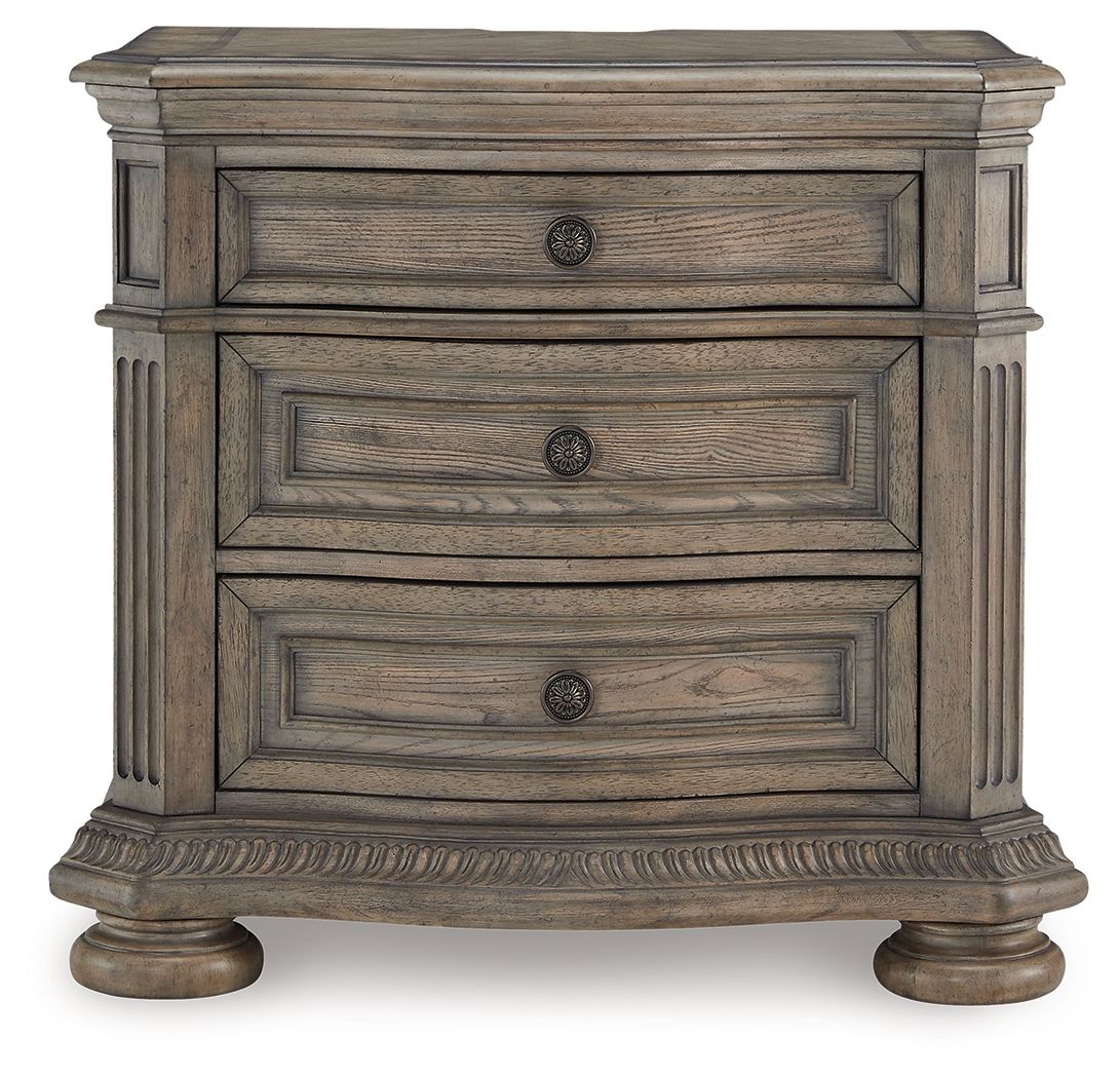 Light brown nightstand with three stacked drawers and round hardware knobs