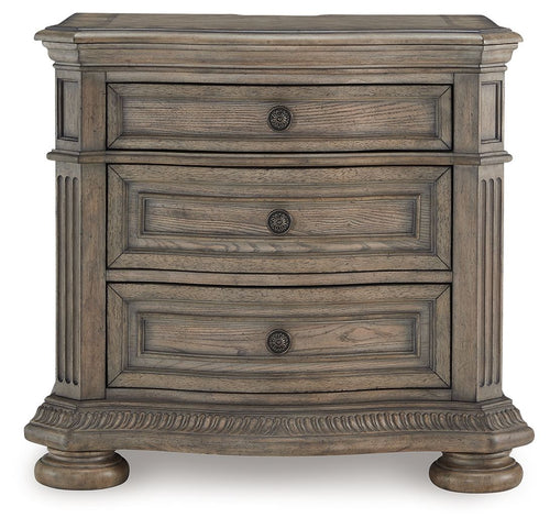 Light brown nightstand with three stacked drawers and round hardware knobs