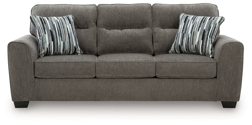 Dark gray fabric sofa with tufted back, square arms, and striped throw pillows