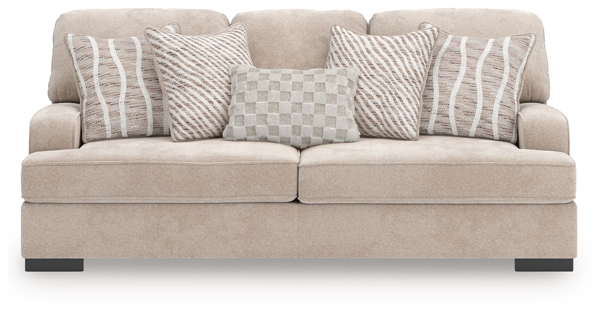 Taupe upholstered sofa with four patterned pillows: striped and checkered designs