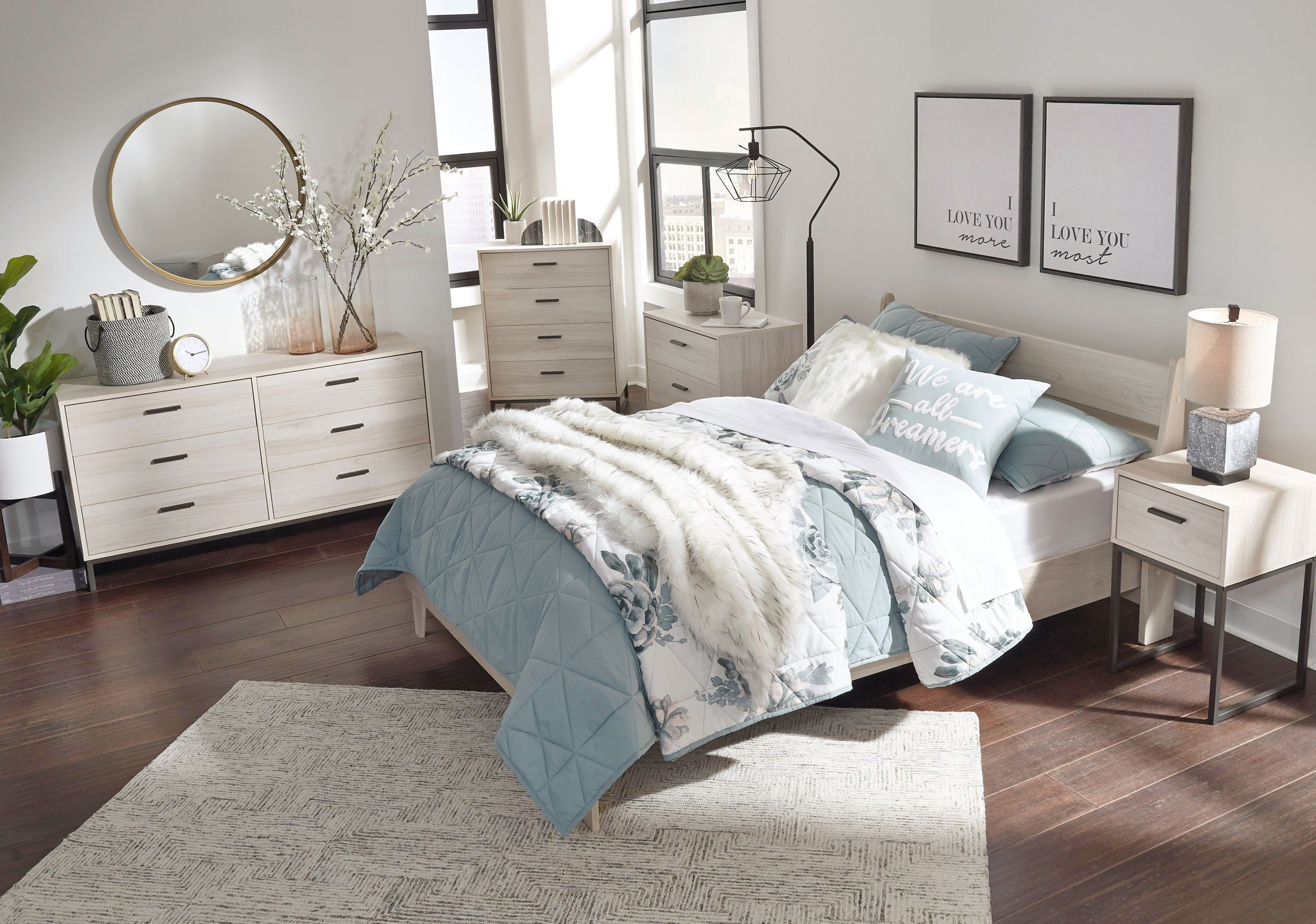 Bedroom furniture set with bed, dresser, and nightstand pieces in light finishes