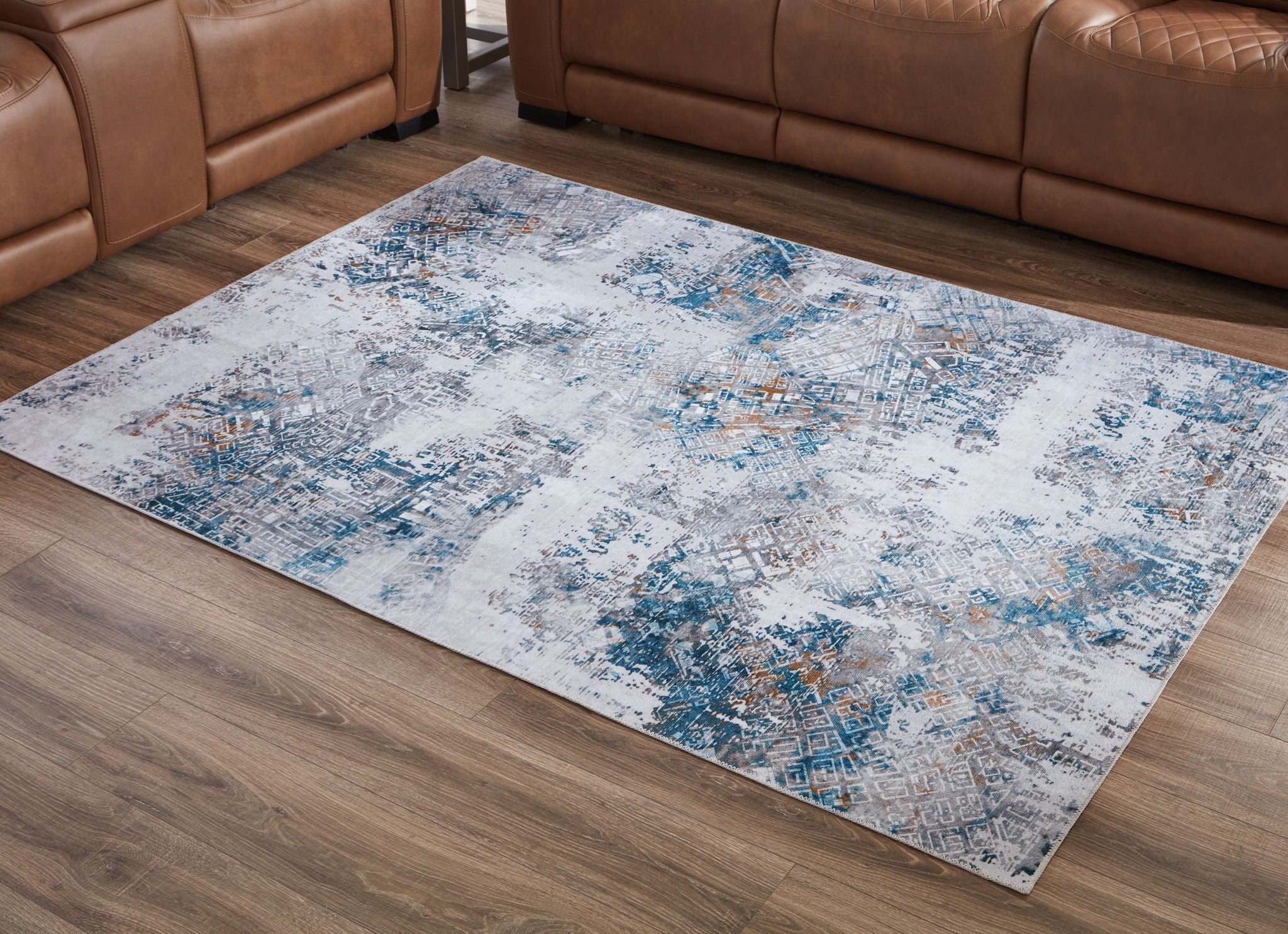 Blue and white abstract 5x7 area rug on hardwood floor