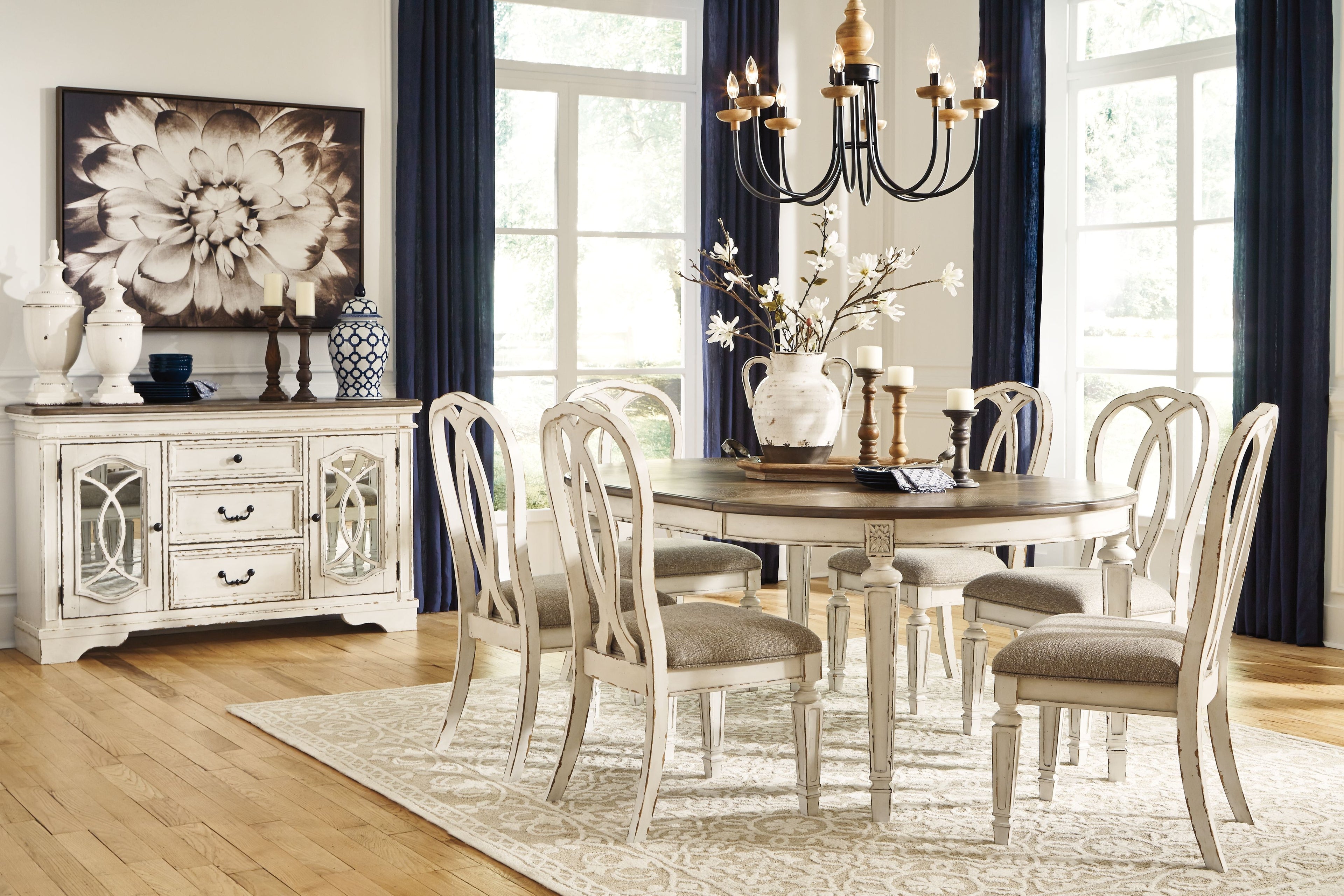 Oval dining table set with white ladderback chairs and gray-brown round tabletop
