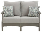 Gray upholstered loveseat with two diamond-pattern throw pillows and square armrests.